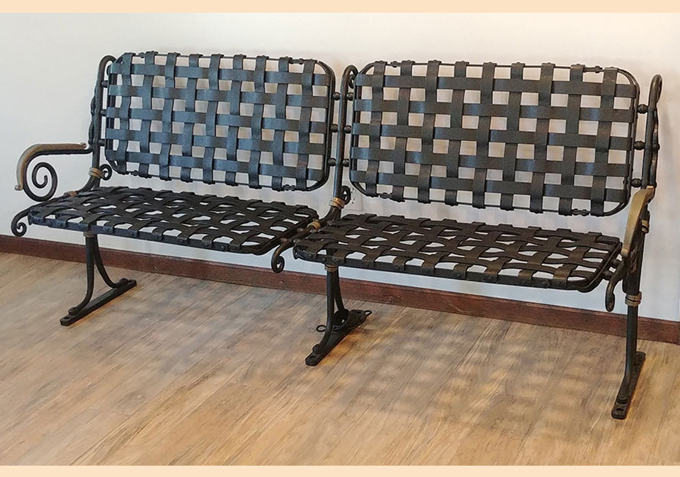 Metal bench with woven metal seat and back created by Arthur Johns.