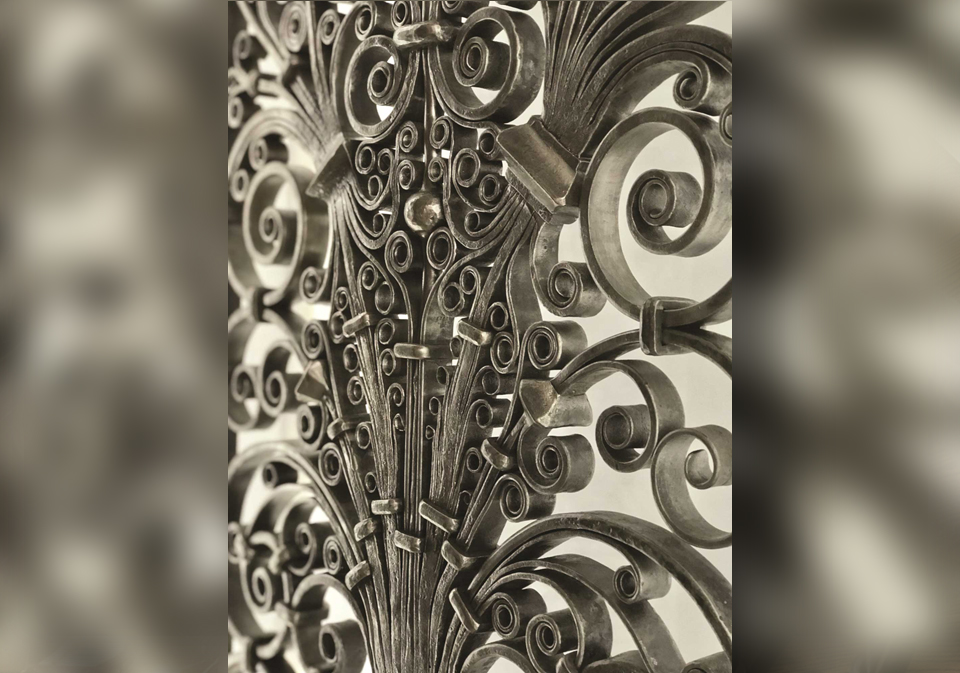 Detail of door with hundreds of forge welded scrolls and collars by India Lee.