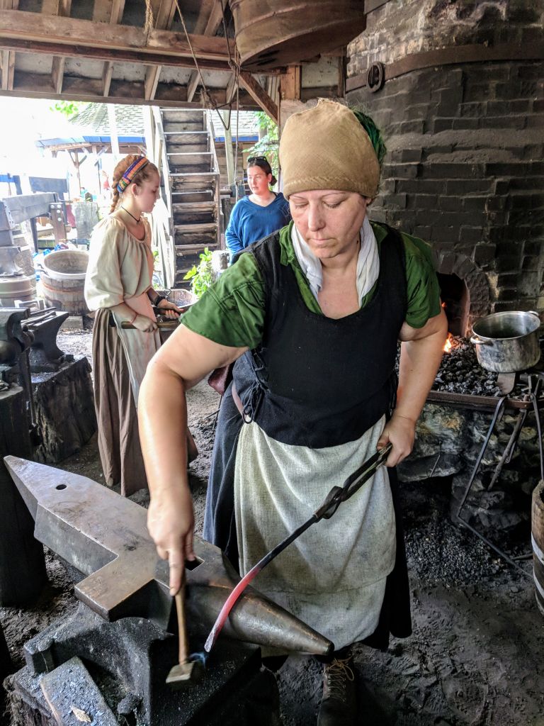 ABANA member, Chelsea Brimer, working the smithy at Deanna Rose Children's Farmstead.