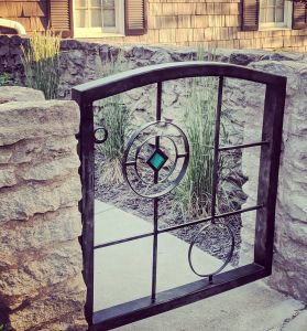 Steel gate with decorative colored glass insert by ABANA member, Chelsea Brimer.